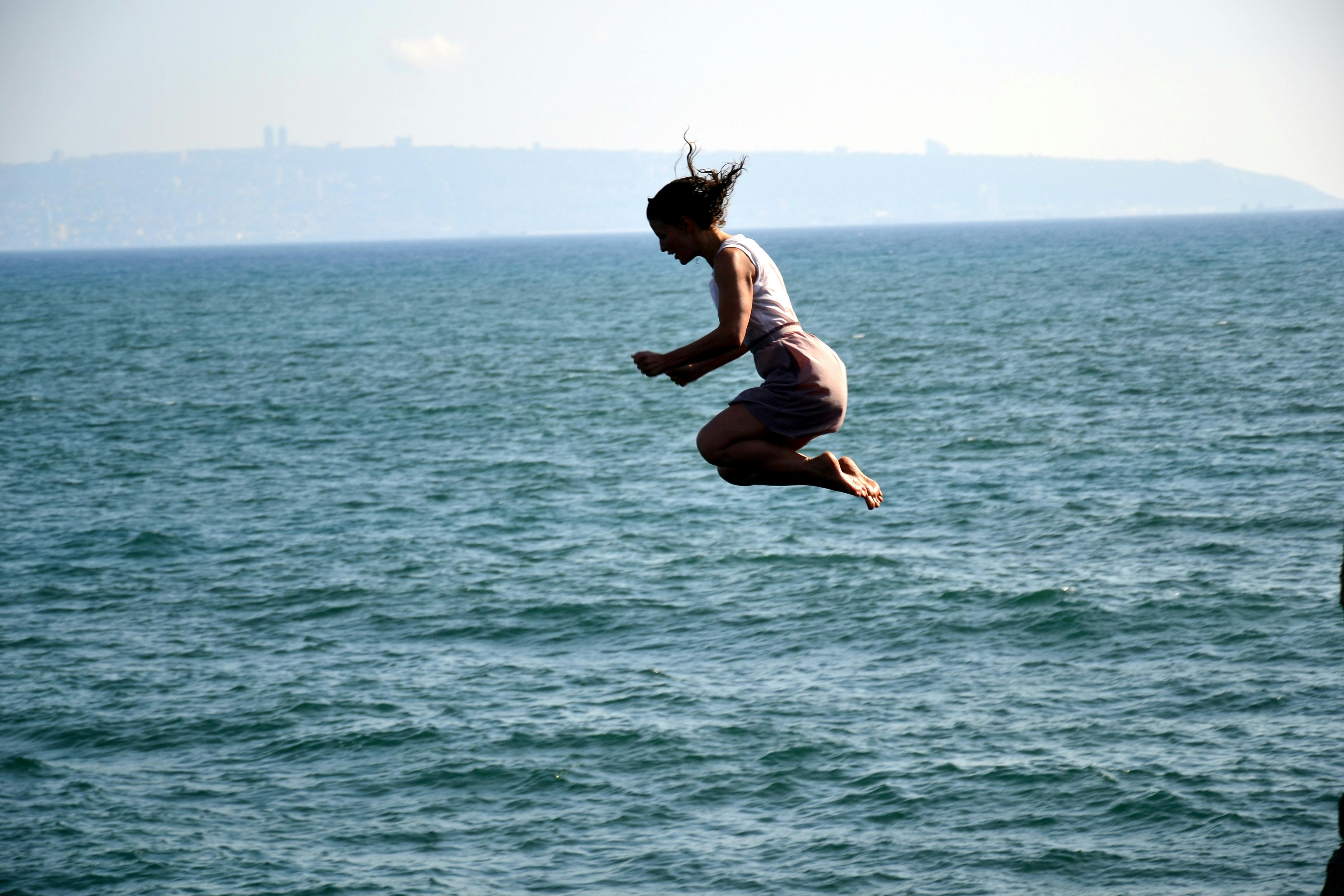 Free stock photo of jump, sea, woman