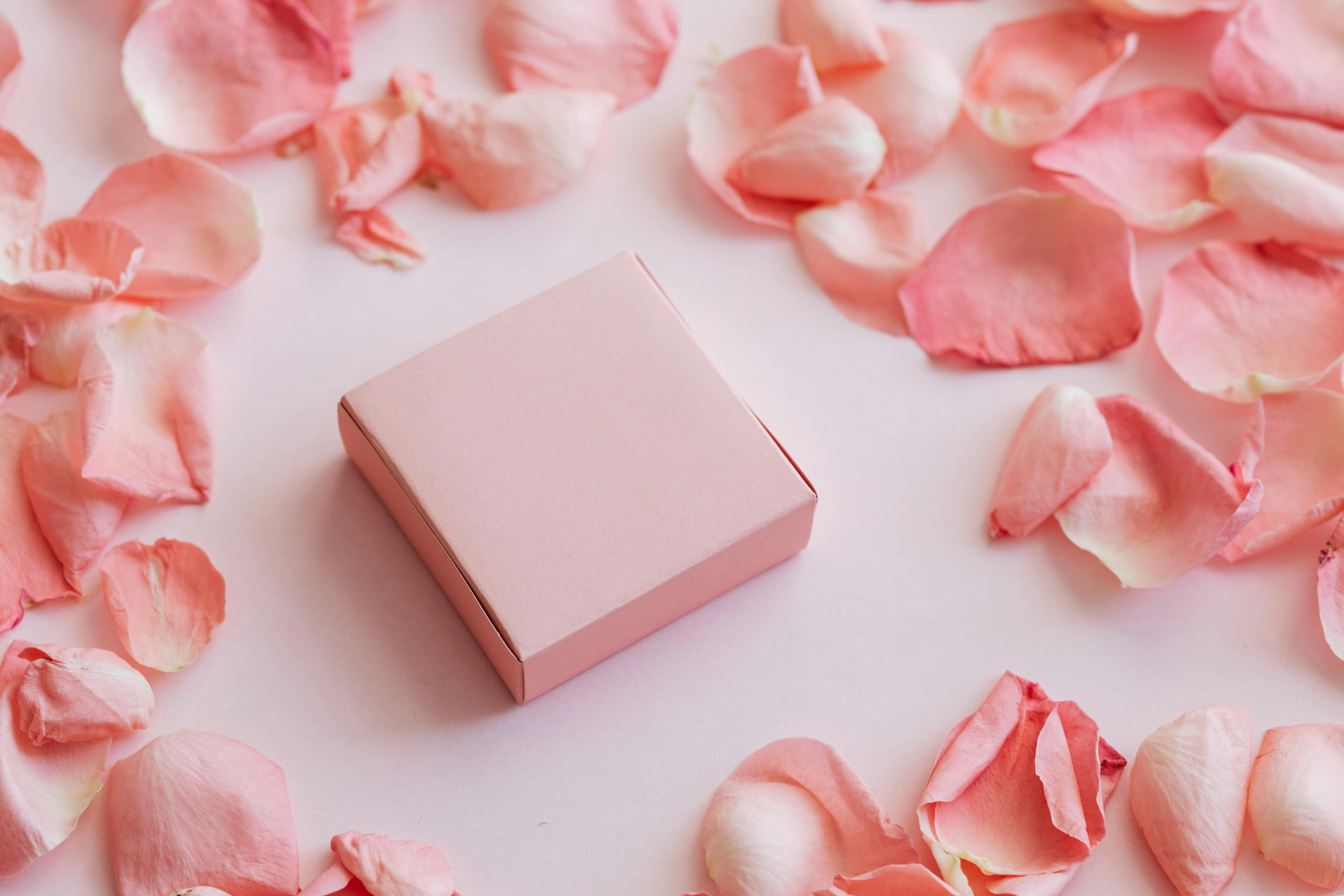 little gift box among rose petals set