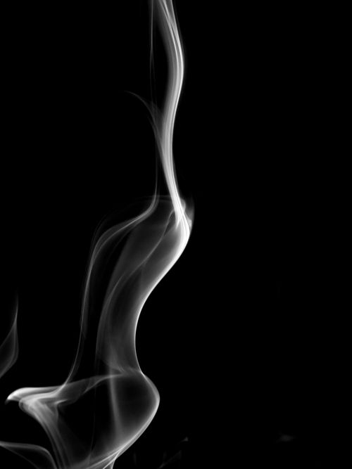 Free Artistic close-up of smoke wisps on a black backdrop, evoking mystery and elegance. Stock Photo
