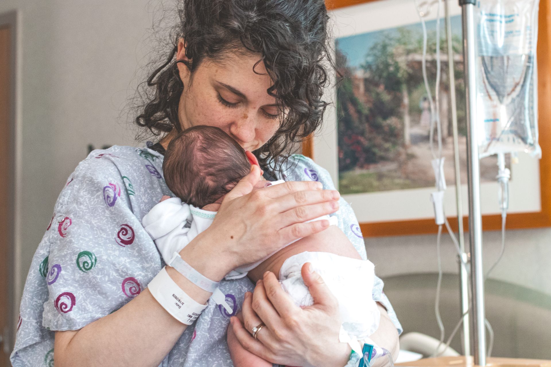 Mother gently holding newborn baby