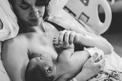 Free Monochrome Photograph of a Woman Carrying an Infant Stock Photo