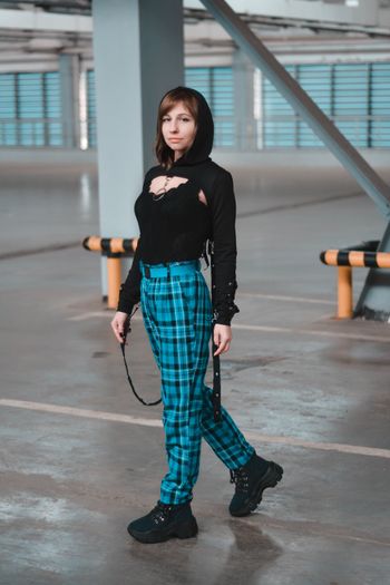 Tartan trousers with a black shirt — photo by Vika Glitter on Pexels