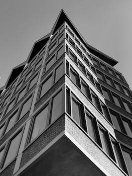 Striking black and white photo of a contemporary building in Amsterdam with unique geometric design.