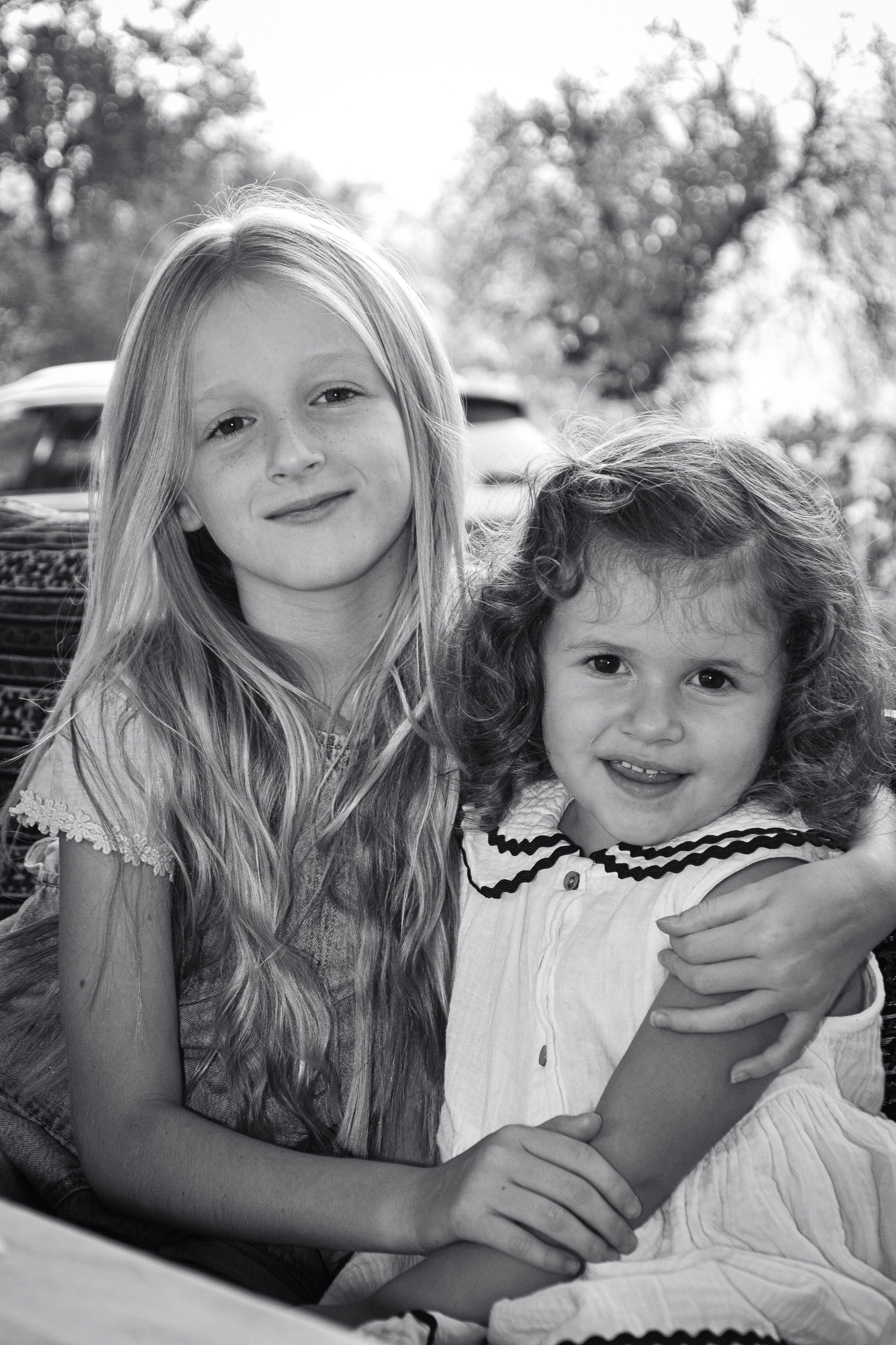 Black and White Portrait of Sisters Embracing · Free Stock Photo