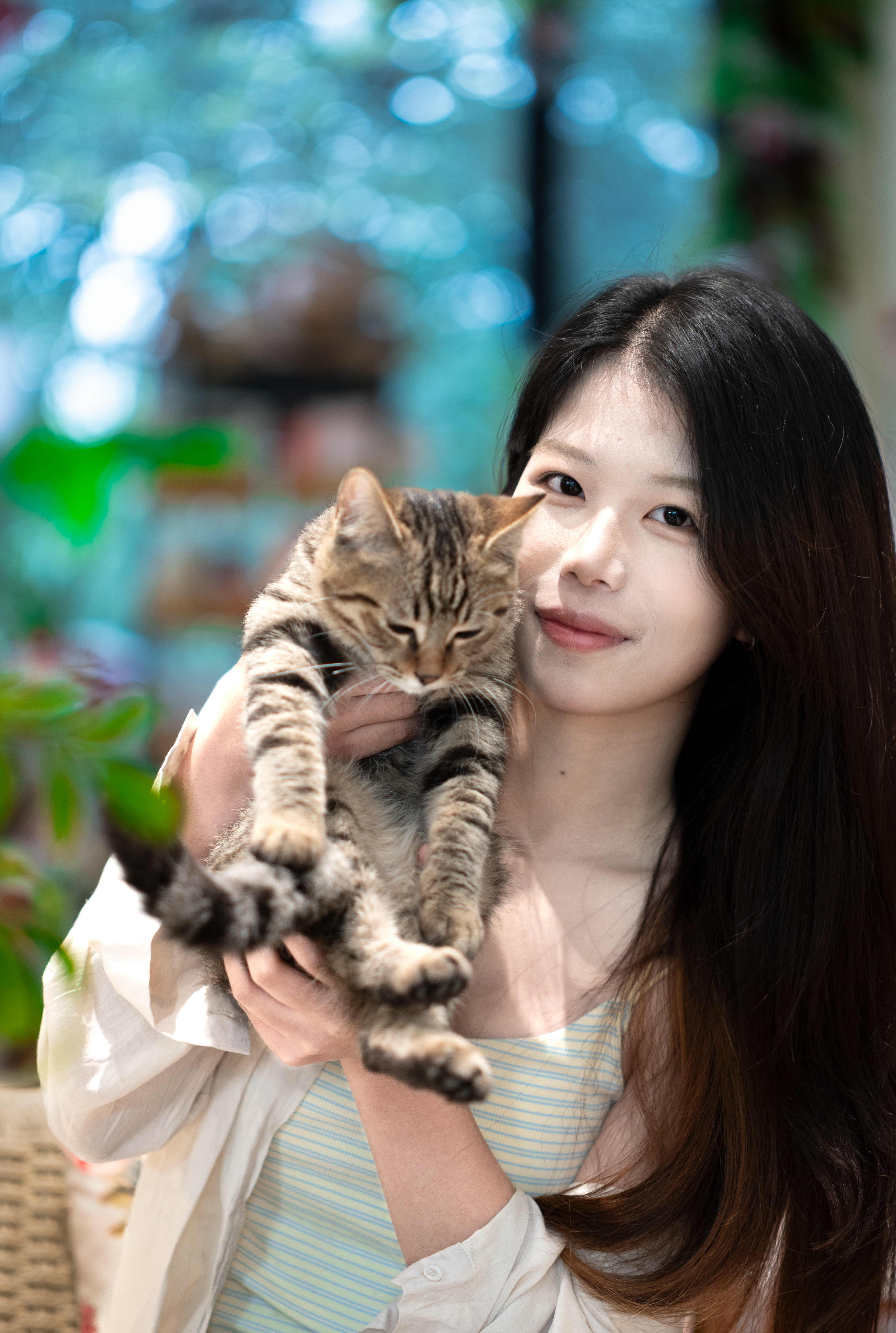 Young Woman Affectionately Holding Her Cat Indoors · Free Stock Photo