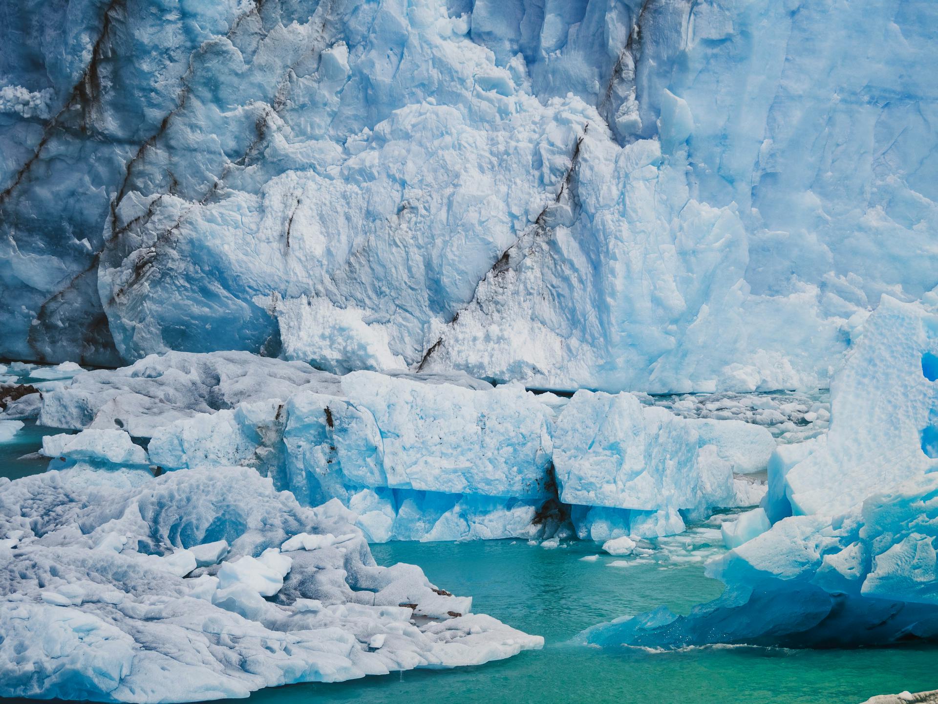 Stunning view of a glacier and iceberg in Patagonia with turquoise waters, depicting winter's chill.