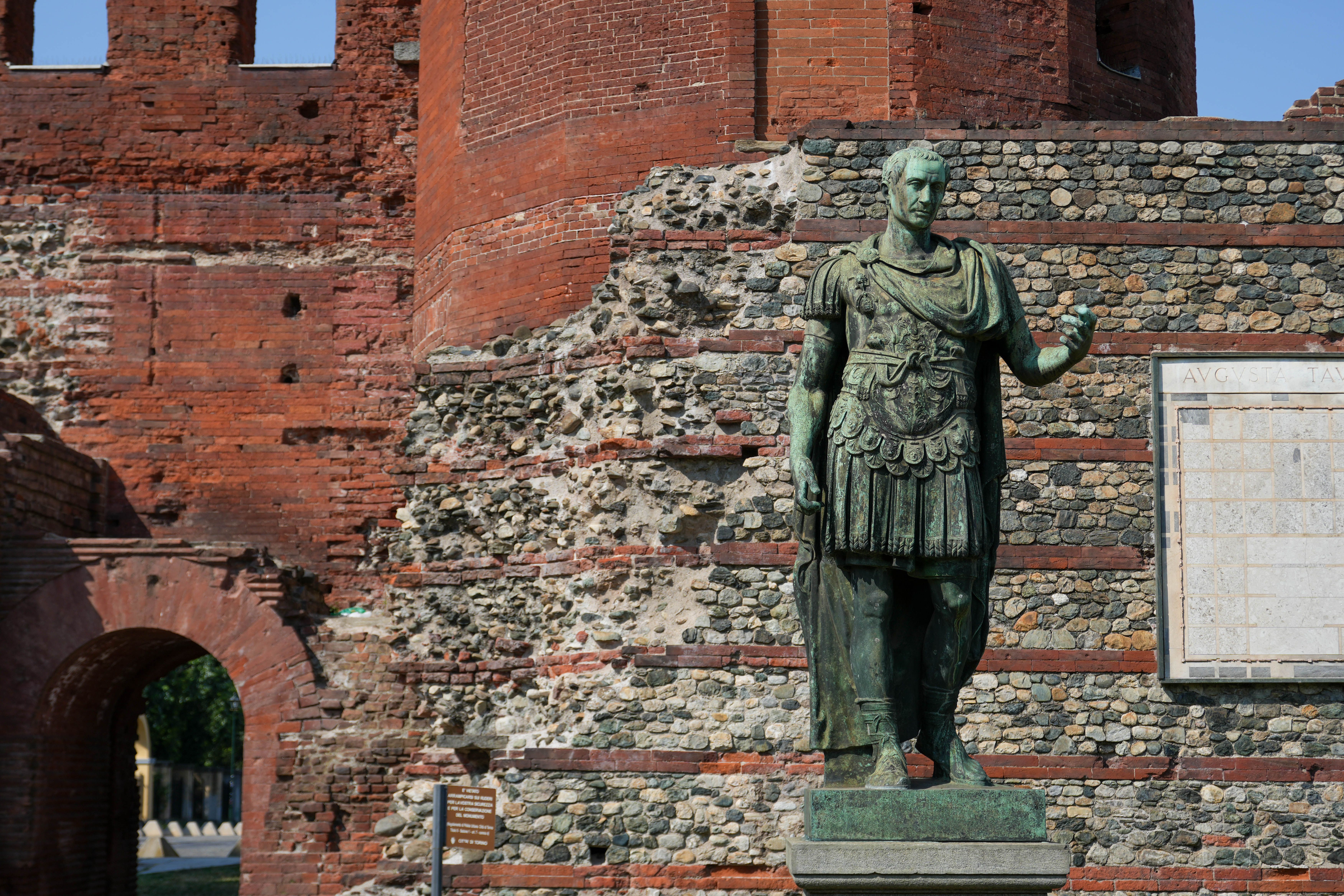 Ancient Roman Statue at Historic Brick Ruins · Free Stock Photo