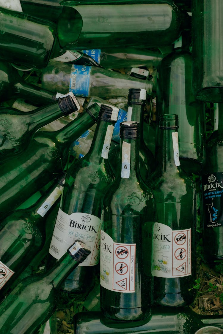 Green Glass Bottles On White Table