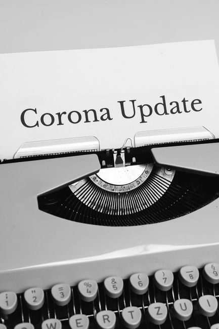 Photo by Markus Winkler Black and white photo of a typewriter with 'Corona Update' paper, reflecting news and communication.