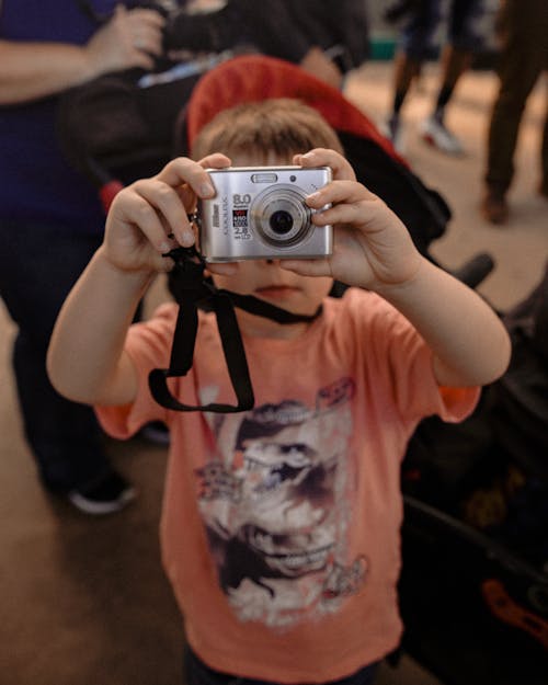 Little kid with photo camera on street