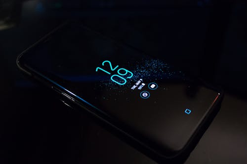 Free Turned-on Black Samsung Android Smartphone Displaying Clock at 12:09 Stock Photo