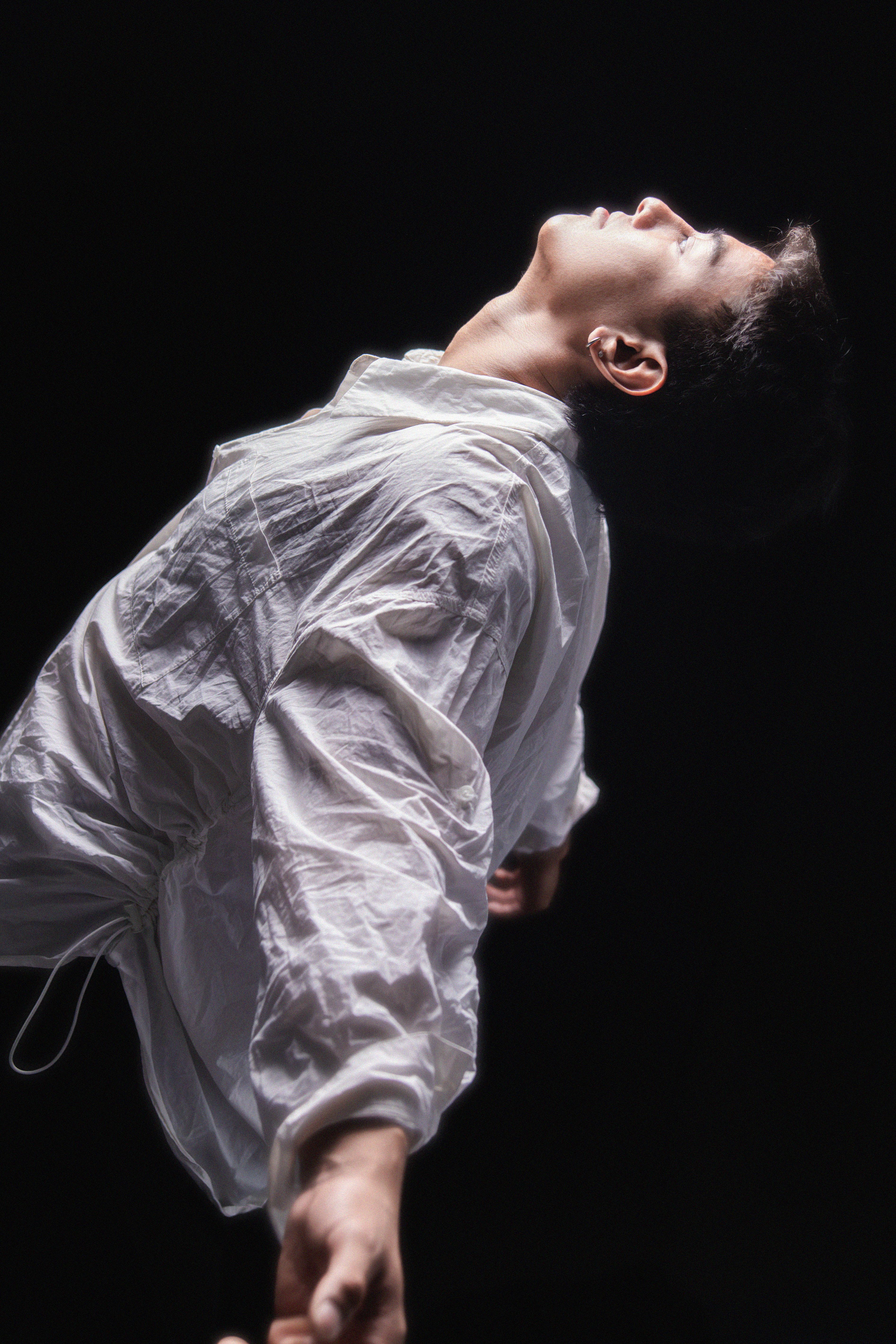 Dynamic Dance Pose in Dramatic Lighting · Free Stock Photo