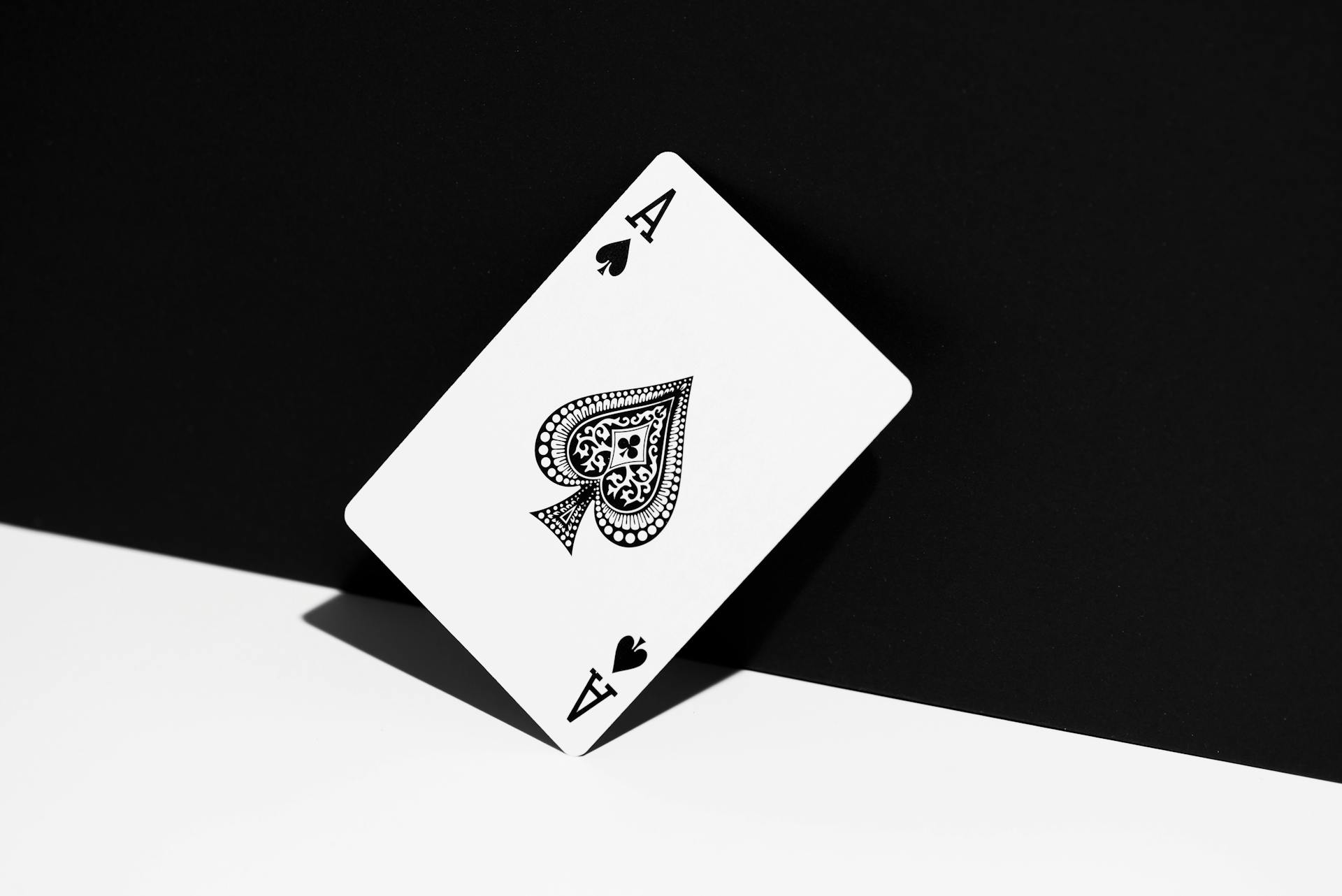 Ace of Spades playing card standing against a black and white background. Perfect for gambling and gaming themes.