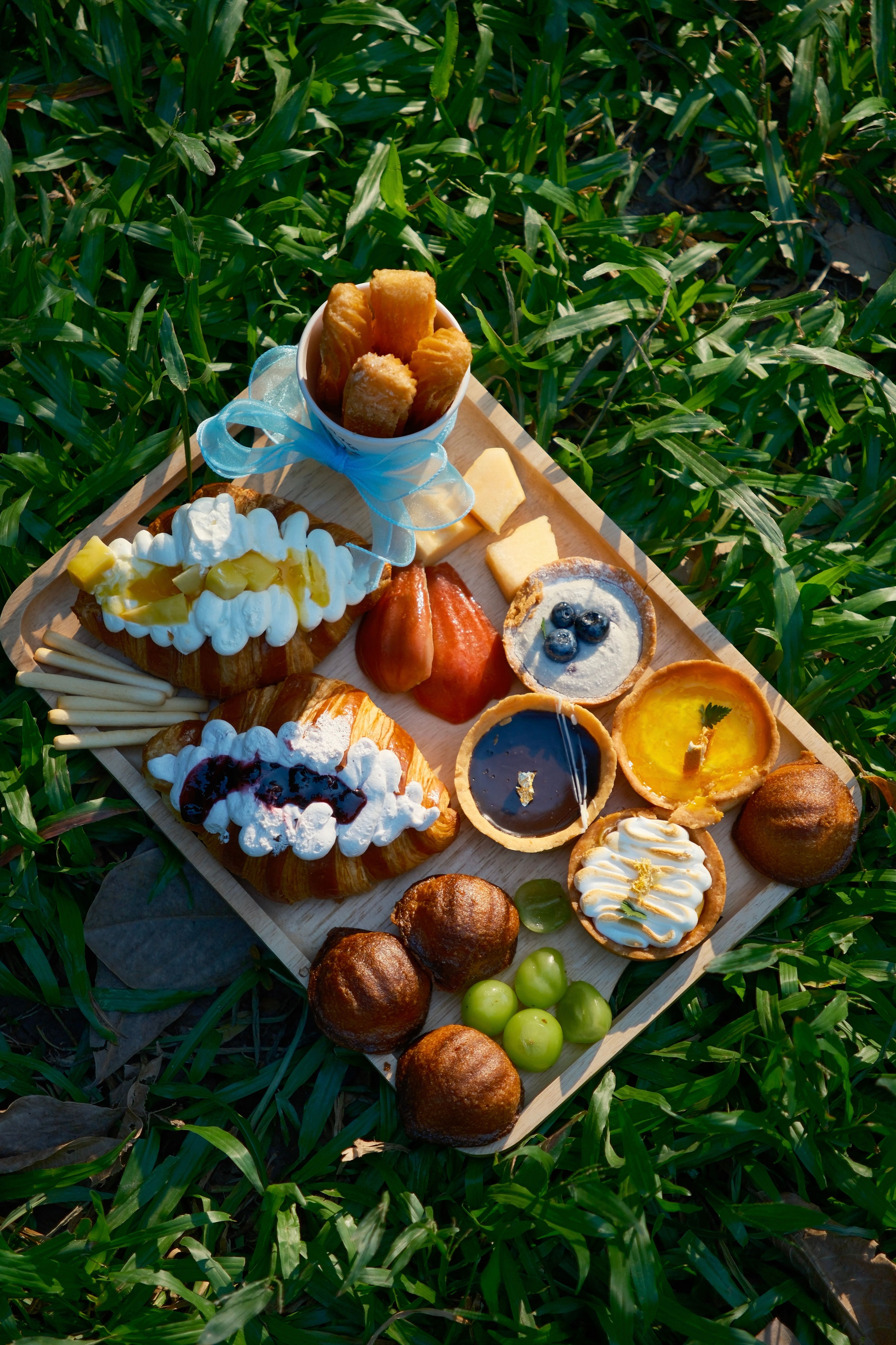 Delicious Picnic Dessert Spread on Grass · Free Stock Photo