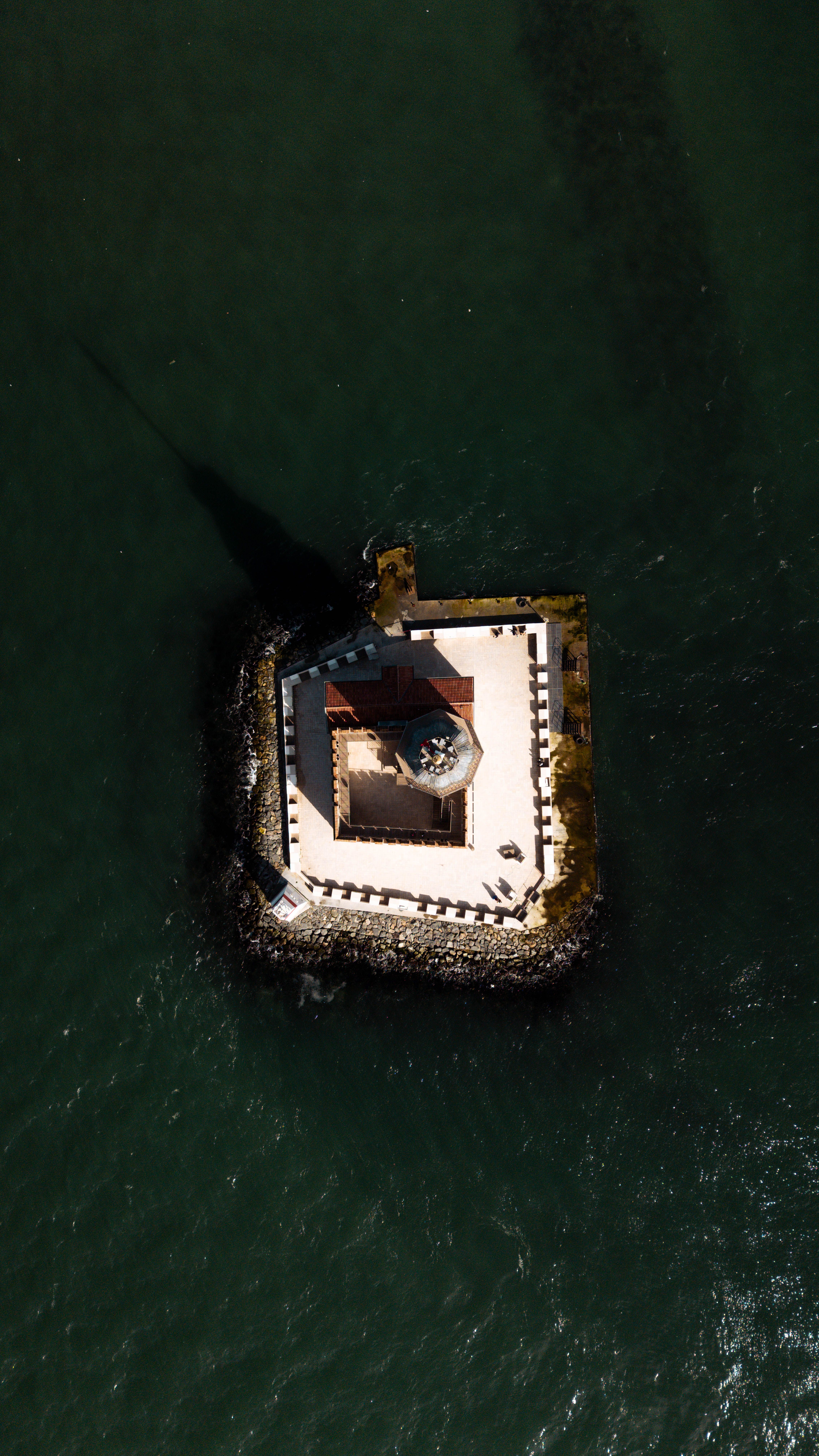 Aerial View of Isolated Lighthouse in Ocean · Free Stock Photo