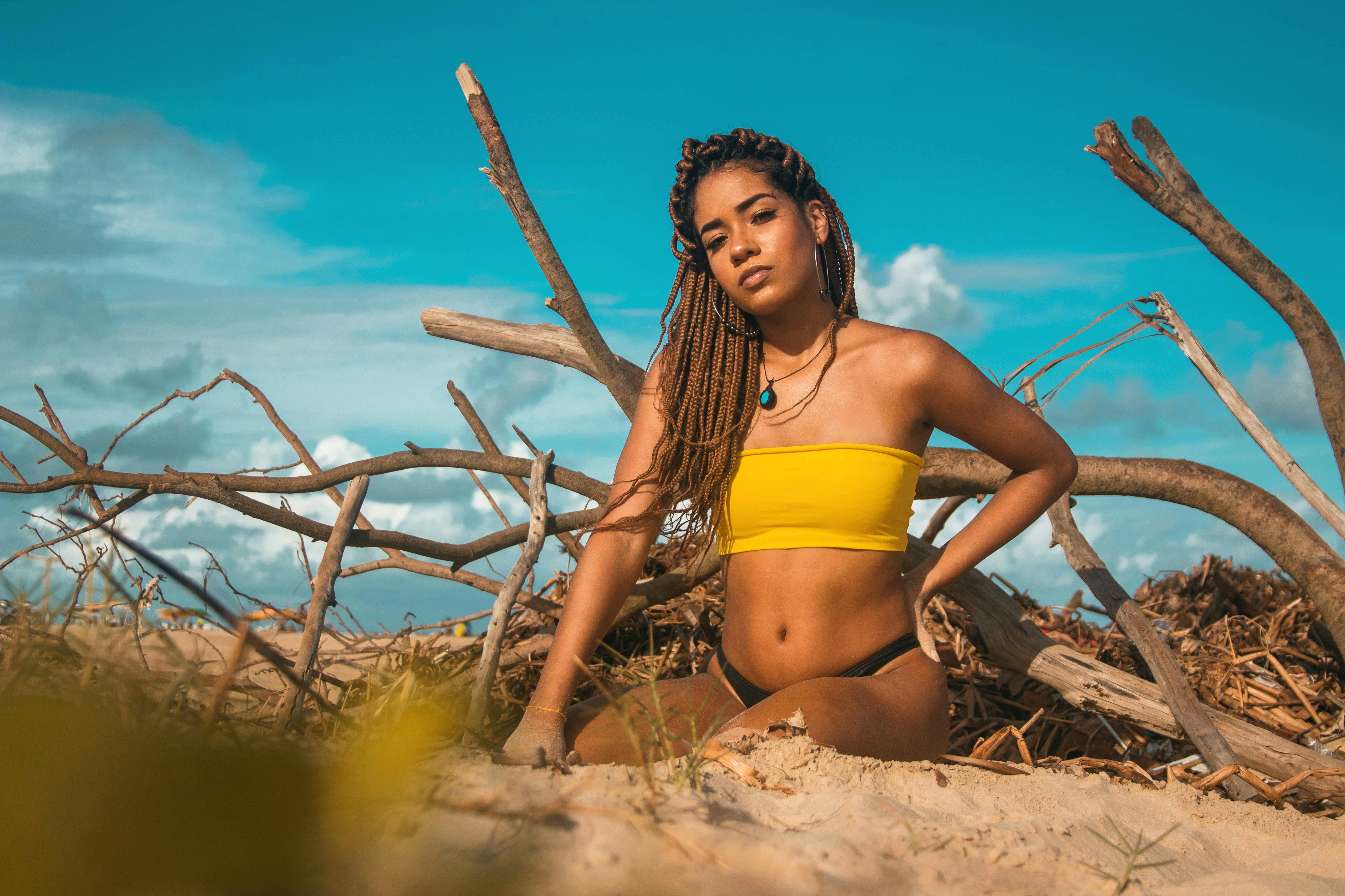 Cool female in bikini on sandy coast · Free Stock Photo
