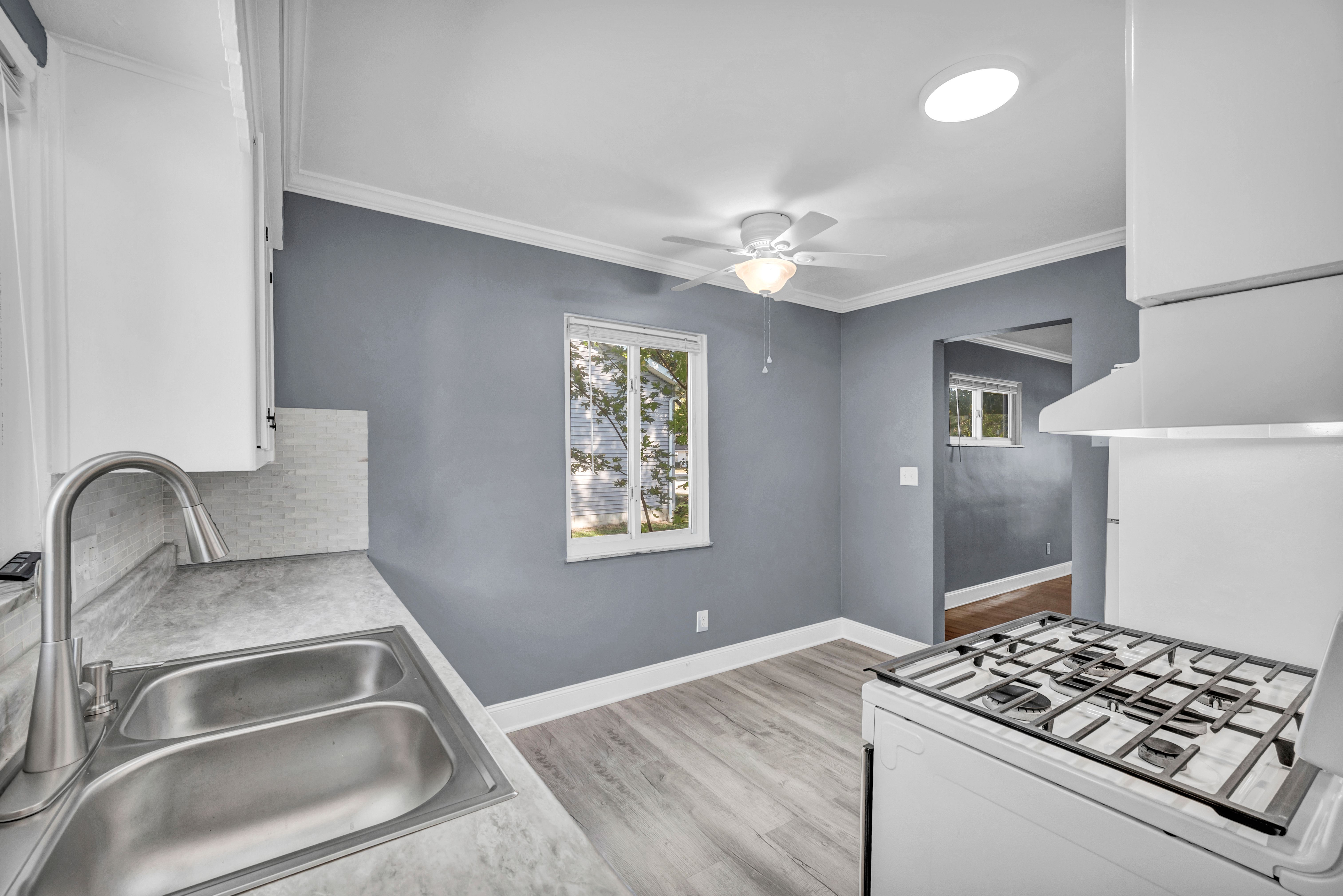 Bright and modern kitchen with gray walls and updated appliances in an Ohio home.
