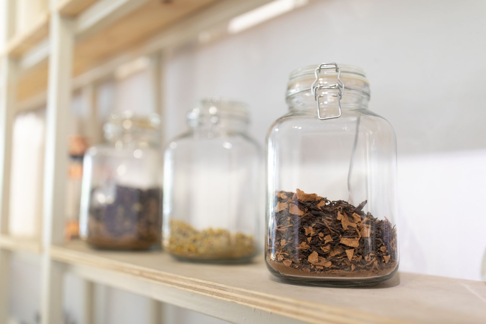Glass apothecary jars on a sunlit shelf — photo by Claudio Olivares Medina on Pexels
