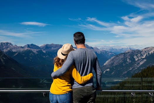 A couple embraces while enjoying a breathtaking view of the mountains in Banff, Alberta.