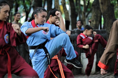 Free Teen martial artists practicing karate outdoors in Pasig, emphasizing discipline and skill. Stock Photo