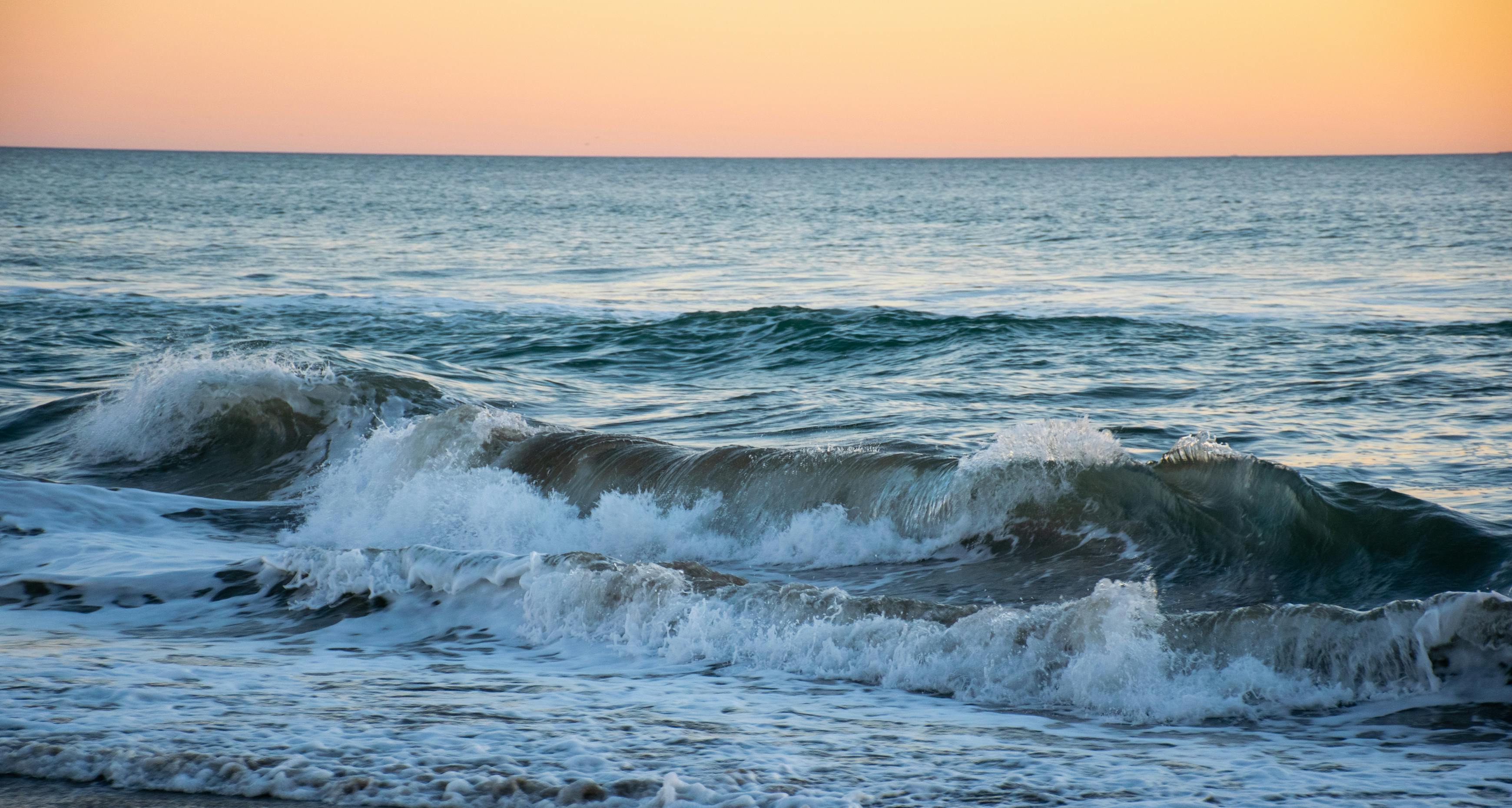 Ocean Waves Crashing On Shore During Sunset · Free Stock Photo
