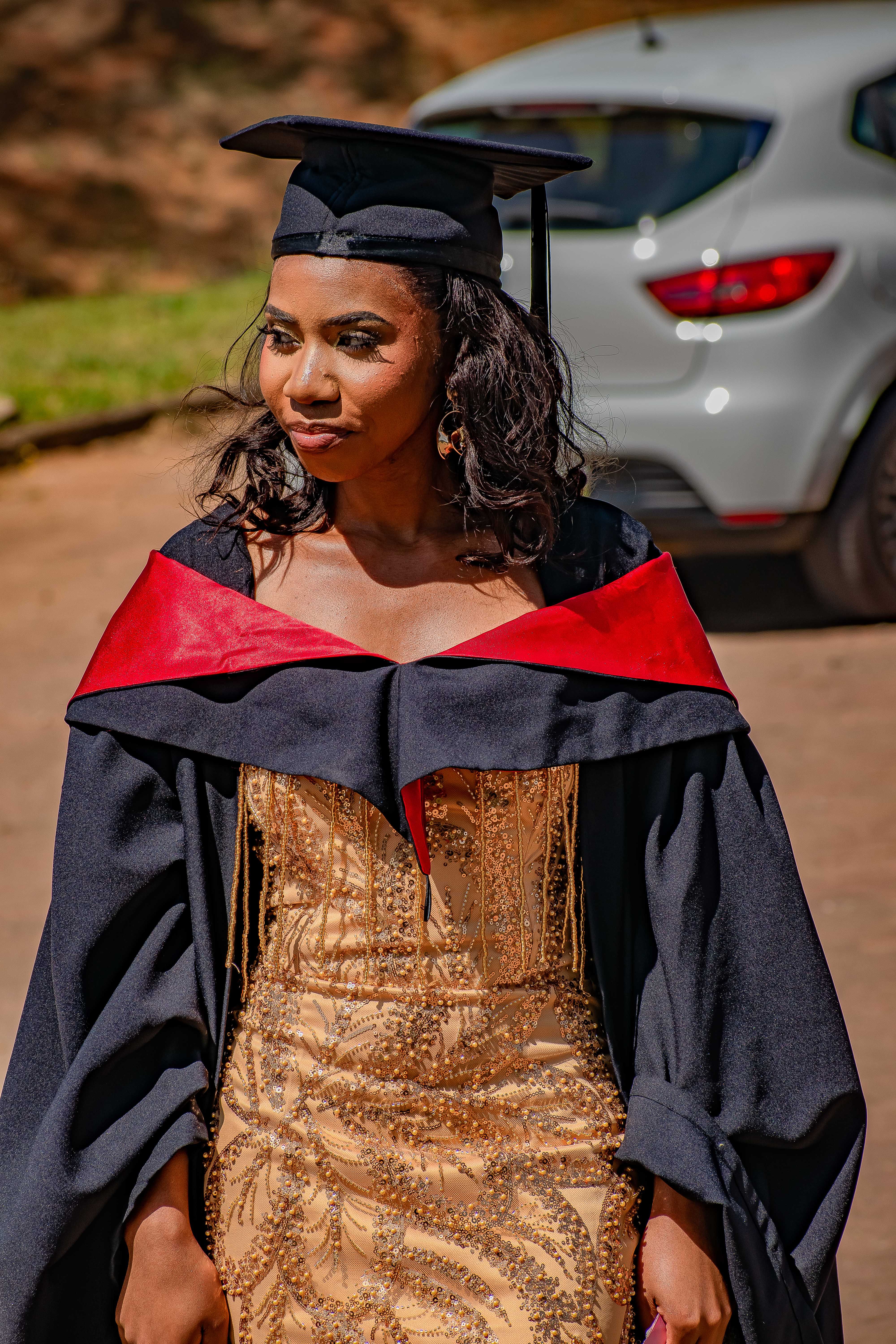 African Woman in Graduation Gown Celebrates Achievement · Free Stock Photo