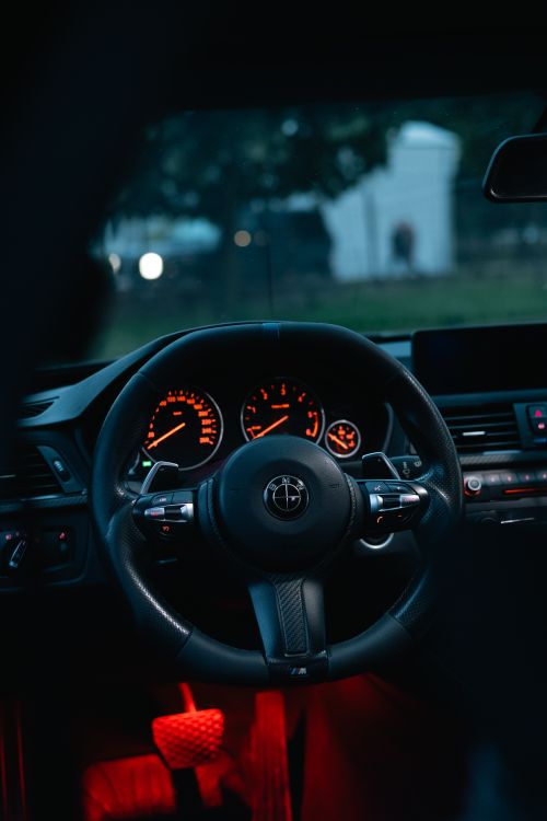 Free Dynamic interior view of a car showing illuminated dashboard and steering wheel at night. Stock Photo