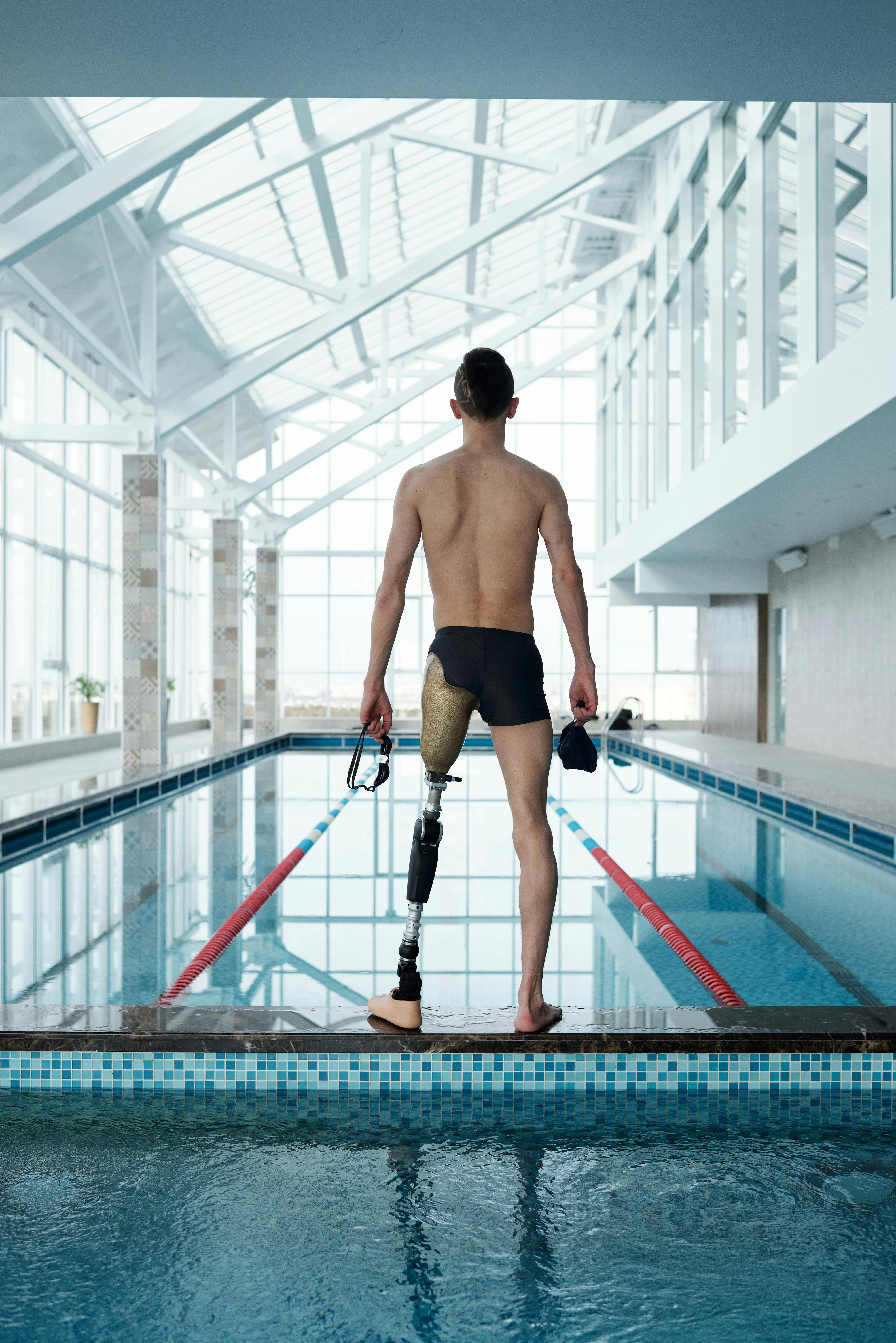 Man With Prosthetic Leg Standing By Swimming Pool · Free Stock Photo