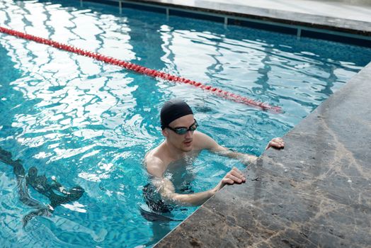 Beginner swimmer using a pull buoy in a pool