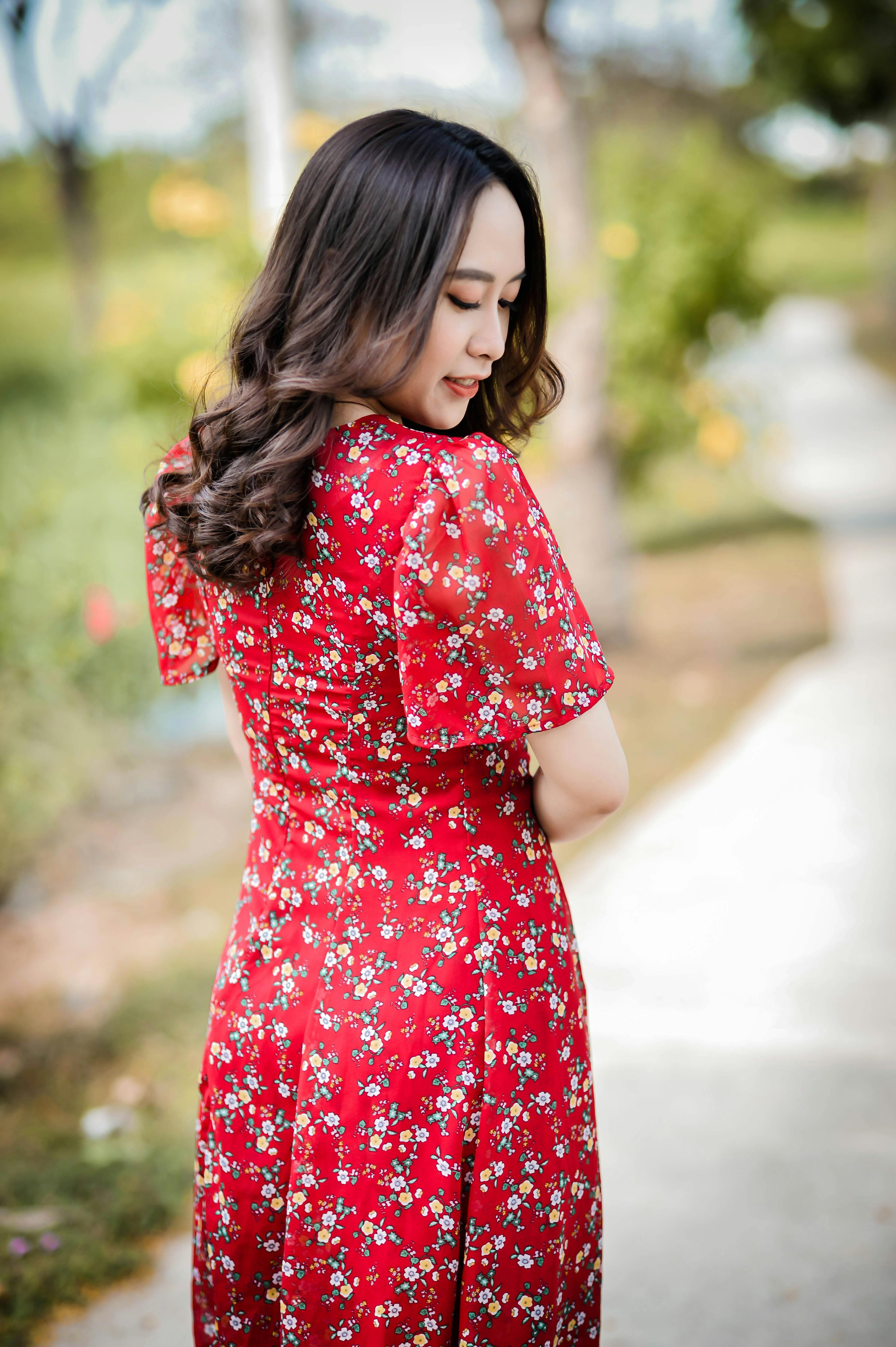 Asian Woman In Bright Dress Standing On Pathway In Park · Free Stock Photo