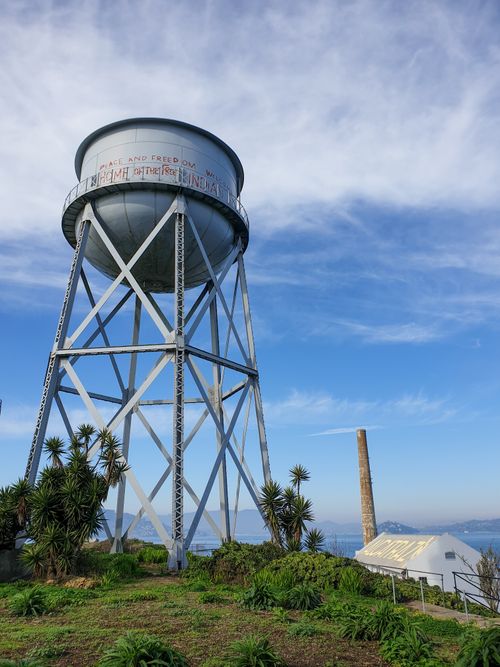 Free Steel water tower on Alcatraz Island with a clear blue sky, captured in San Francisco. Stock Photo