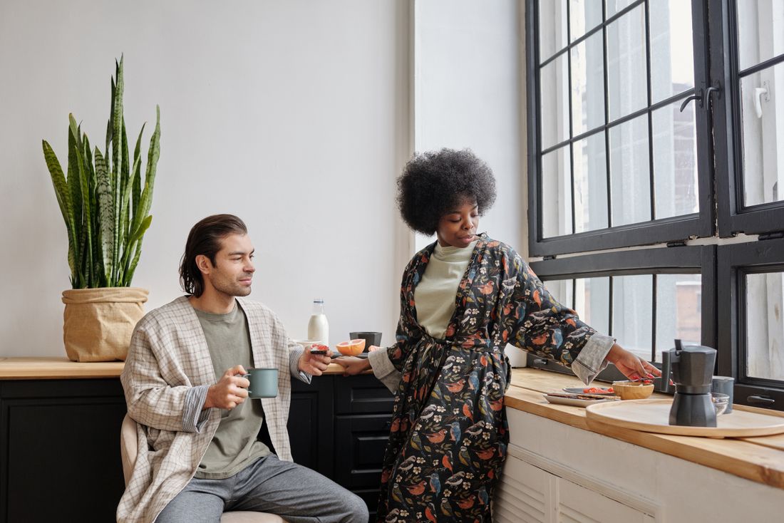 A couple having a calm morning coffee by a sunlit window