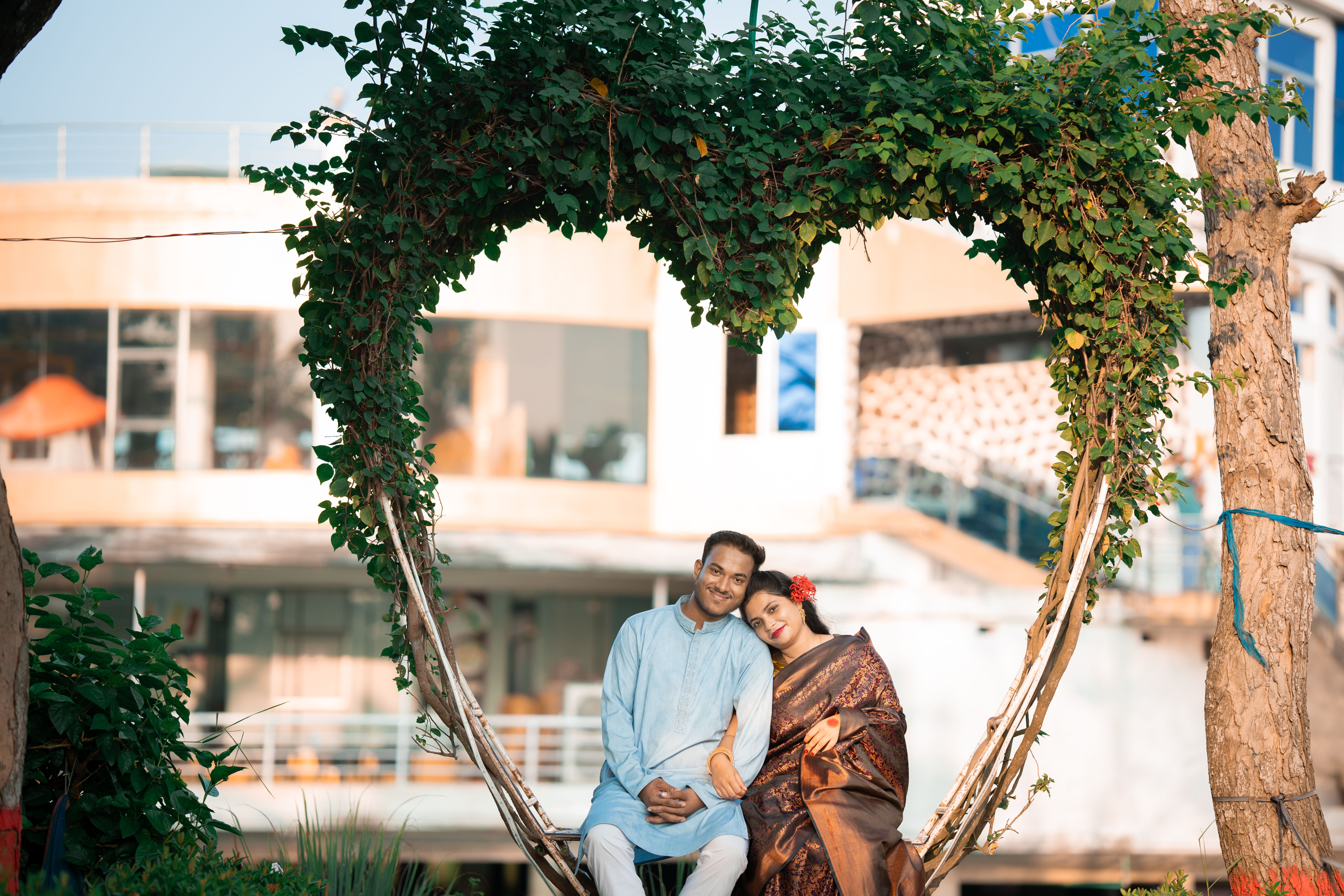 Romantic Couple in Heart-Shaped Vine Frame Outdoors · Free Stock Photo