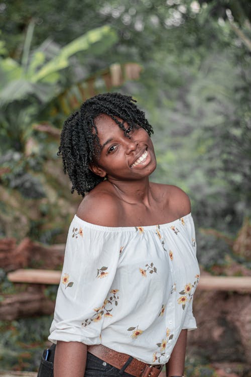 Woman in White Floral Off Shoulder Shirt Smiling