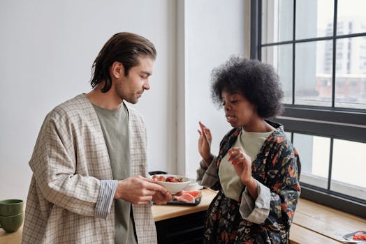 A couple enjoys a relaxed morning sharing breakfast in a bright kitchen by the window.