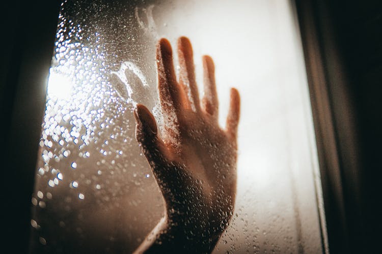 Persons Hand On Glass Window