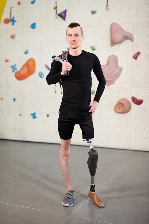 Man in Black Long Sleeve Shirt and Black Shorts Standing With Prosthetic Leg