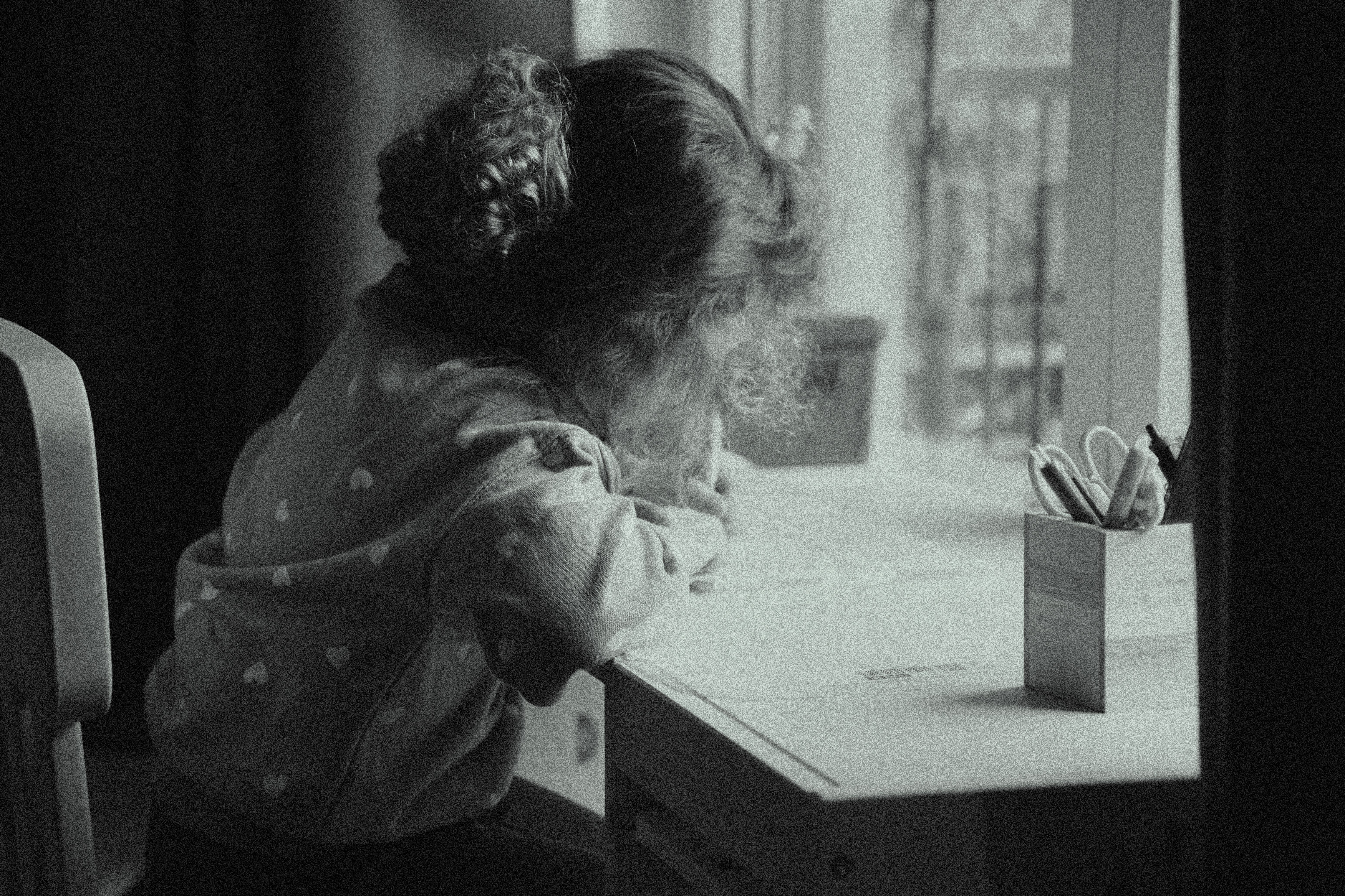 Child Drawing by Window in Black and White · Free Stock Photo
