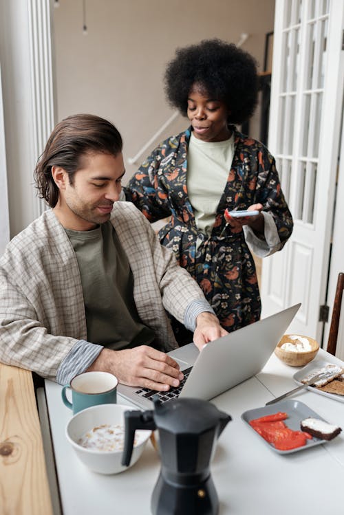 Man Using Laptop During Breakfast