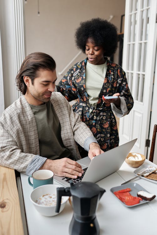 Free Man Using Laptop During Breakfast Stock Photo