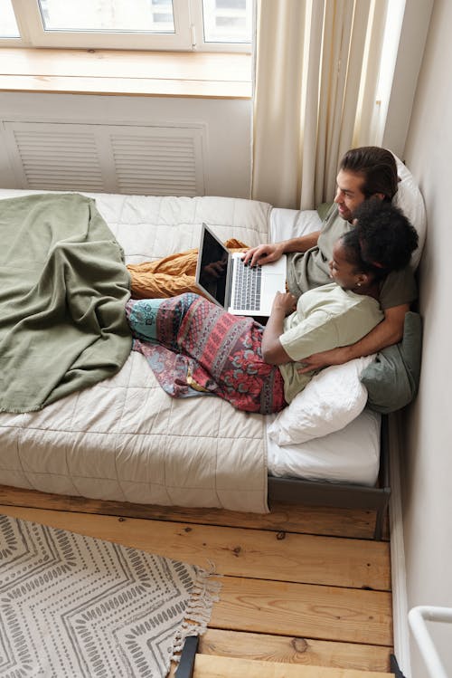 Free Couple in Bed With a Laptop Stock Photo