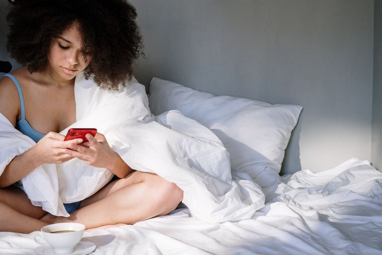 A person using a phone in soft morning light — photo by cottonbro studio on Pexels