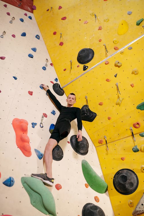 Man in Black Shorts Doing Wall Climbing