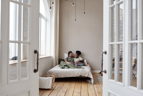 Free Couple Smiling in Bed Stock Photo