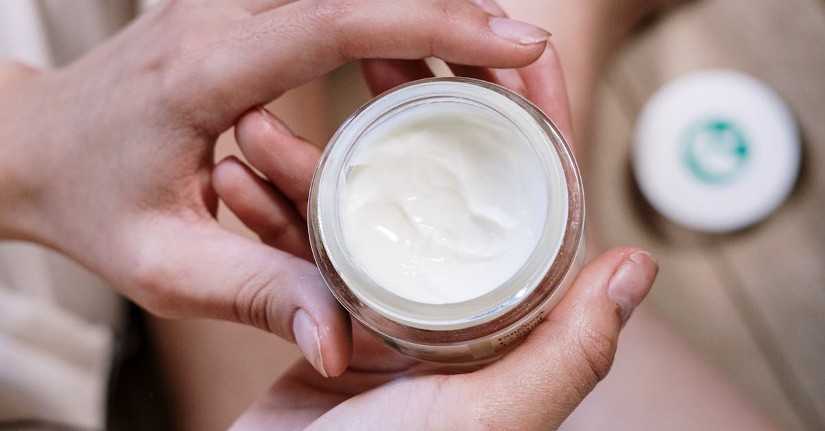 A close-up image of various skincare products like a cleanser, moisturizer, sunscreen, and serum arranged neatly on a bathroom counter.