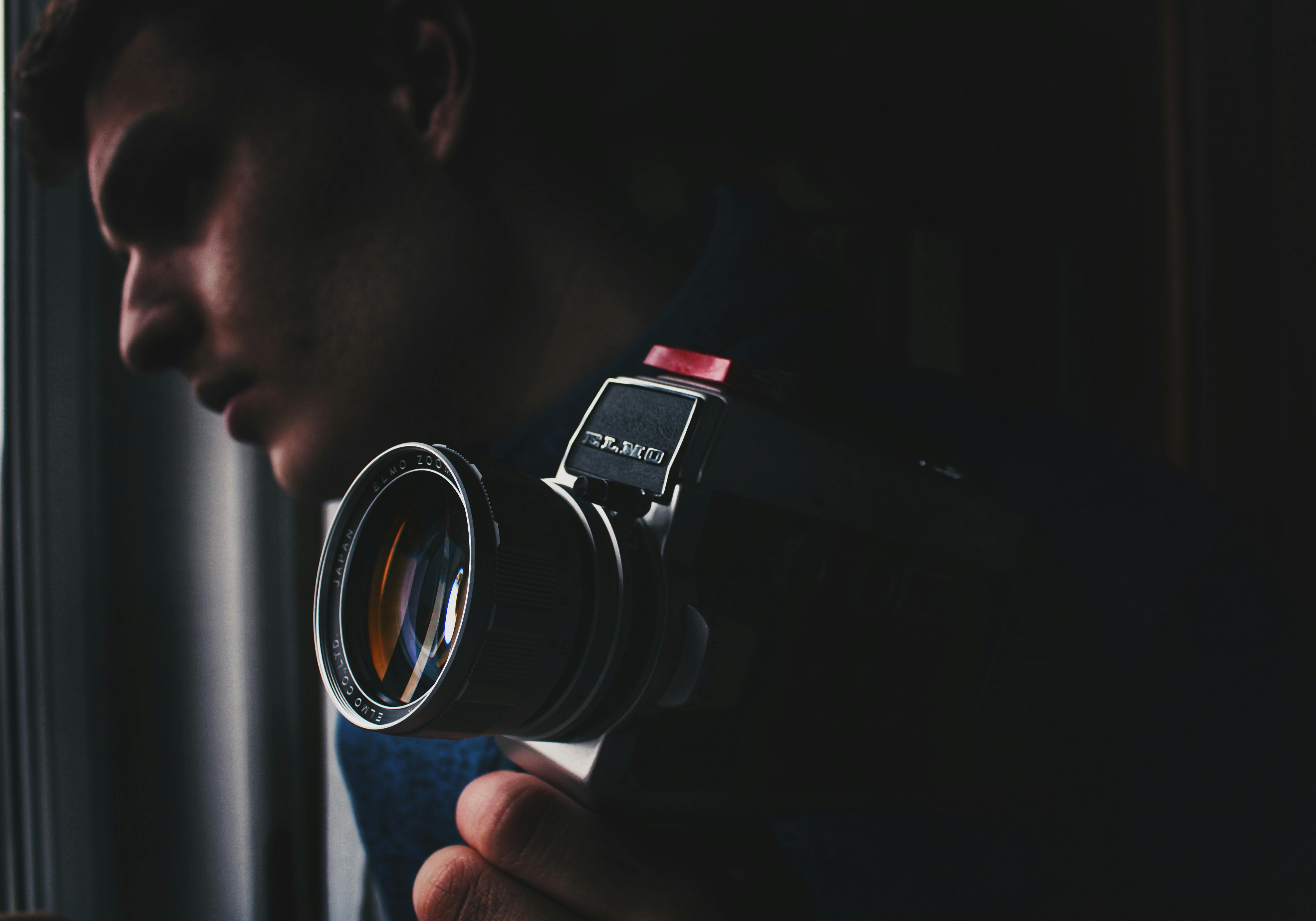 man holding black and silver dslr camera