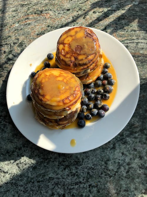 Pancakes with Blueberries on White Ceramic Plate