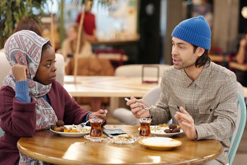 Free Muslim Couple Eating in Restaurant Stock Photo