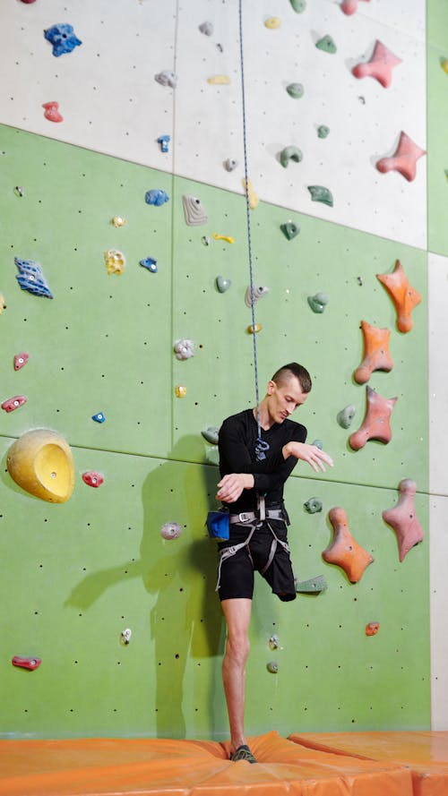 Man in Black Shorts Doing Wall Climbing