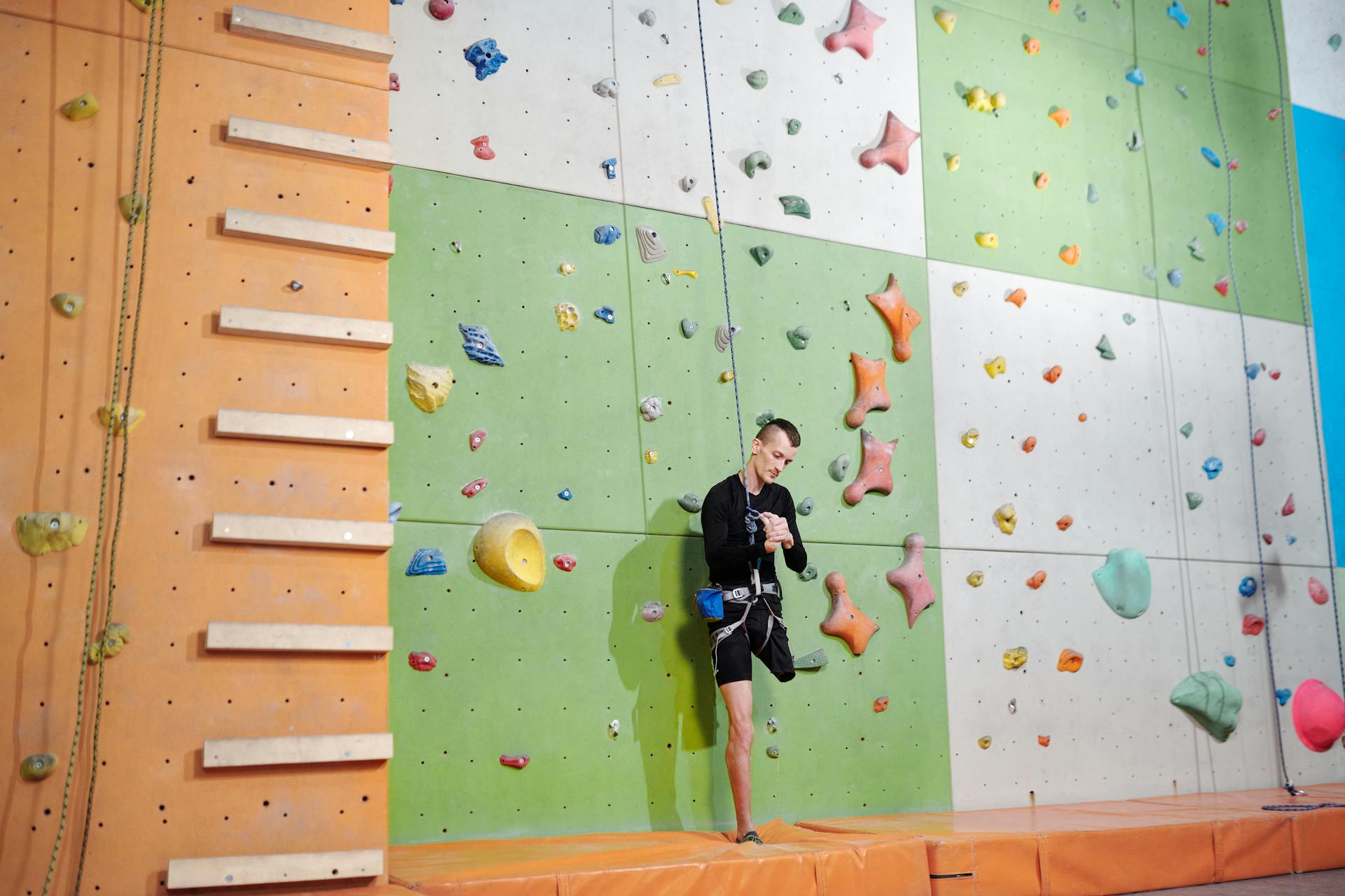 Man in Black Shorts Doing Wall Climbing